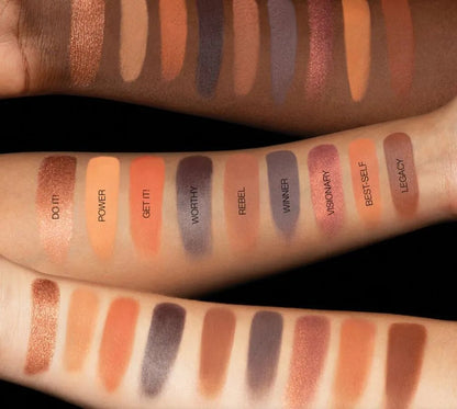 Close-up view of eyeshadow palette with color swatches on skin