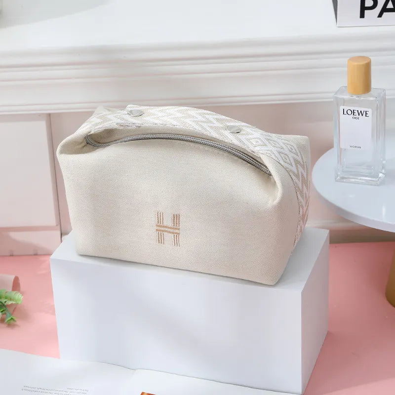 Canvas cosmetics bag with waterproof exterior in lavender color