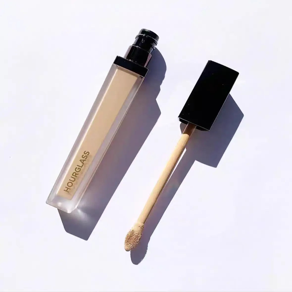 Cream concealer product in a small container with applicator