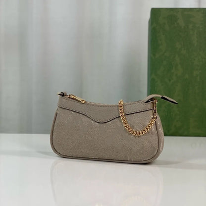 Front view of a small square cosmetic shoulder bag with a structured design