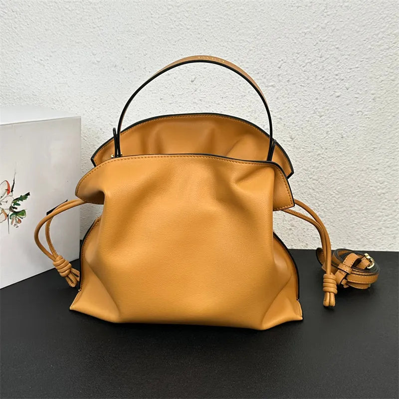 Front view of a leather flamenco clutch bag with chain strap