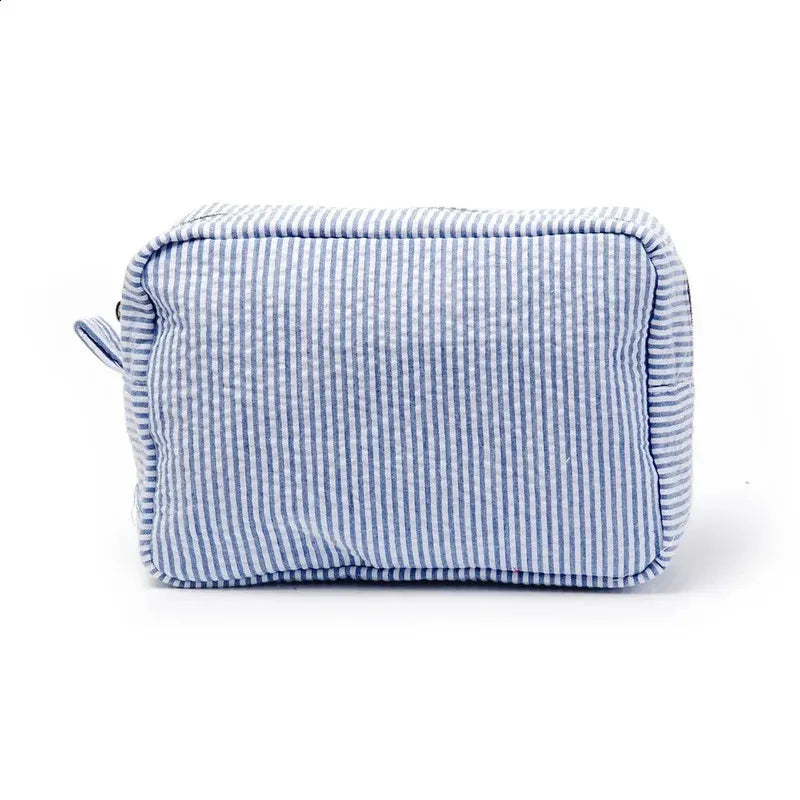 Seersucker cosmetic bag with ruffle detailing and pink purple stripes