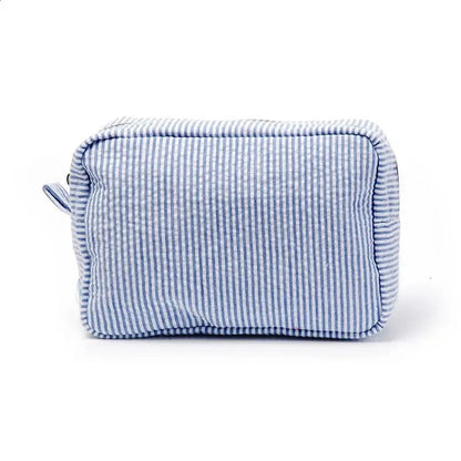 Seersucker cosmetic bag with ruffle detailing and pink purple stripes
