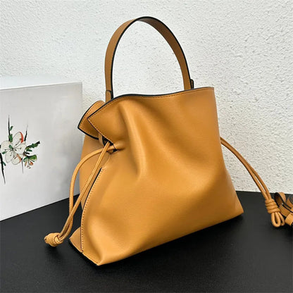 Model wearing the bag as a crossbody with strap attached