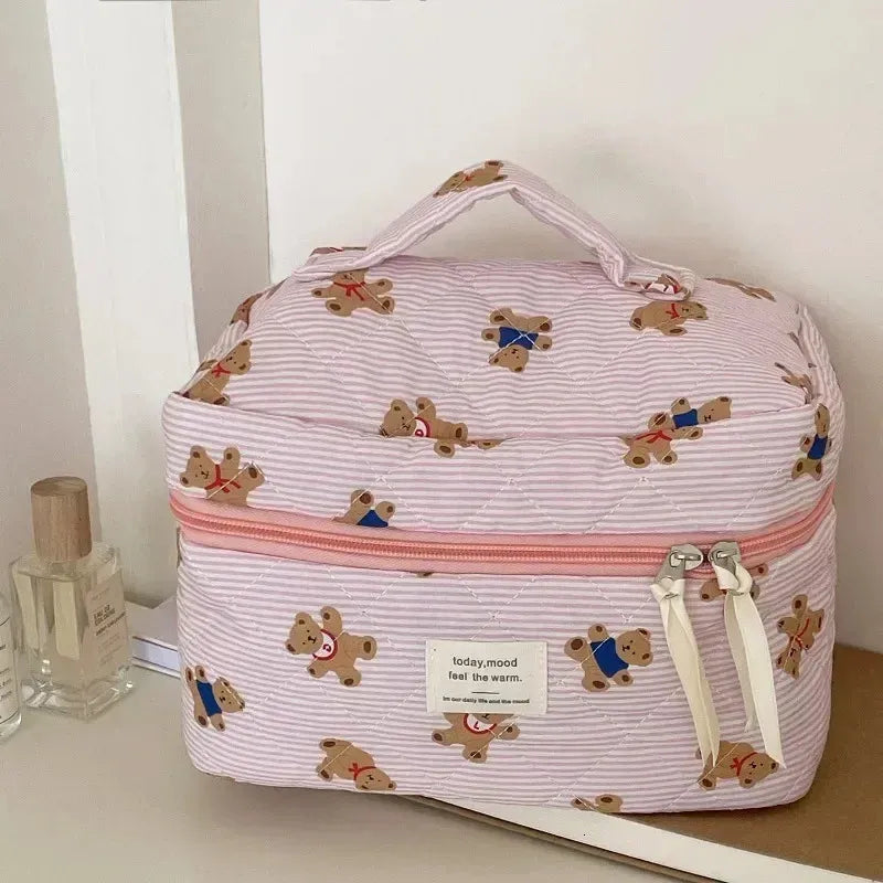 Quilted cosmetic bag with bear design and zipper closure