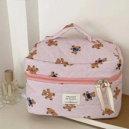 Quilted cosmetic bag with bear design and zipper closure