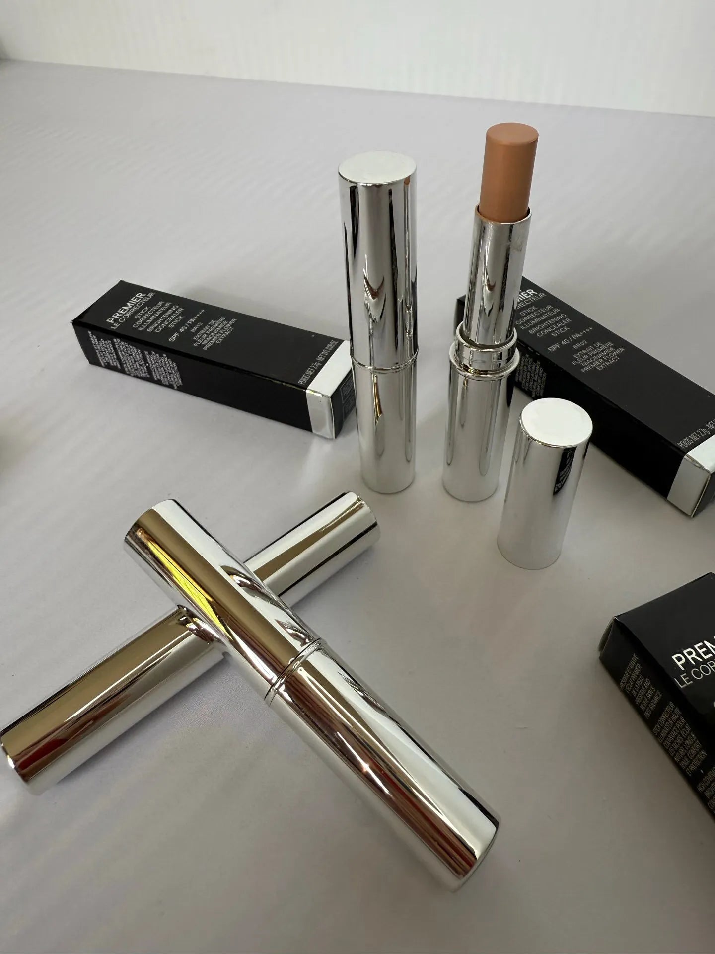 Concealer stick with product visible, demonstrating compact size