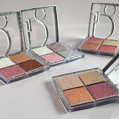 Swatch demonstration of four eyeshadow shades on skin showing pigmentation and finish