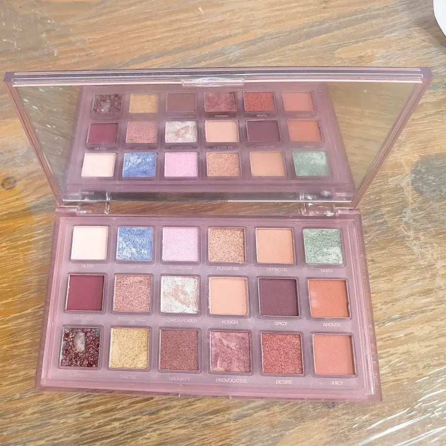 Eyeshadow palette with brush displayed at angle
