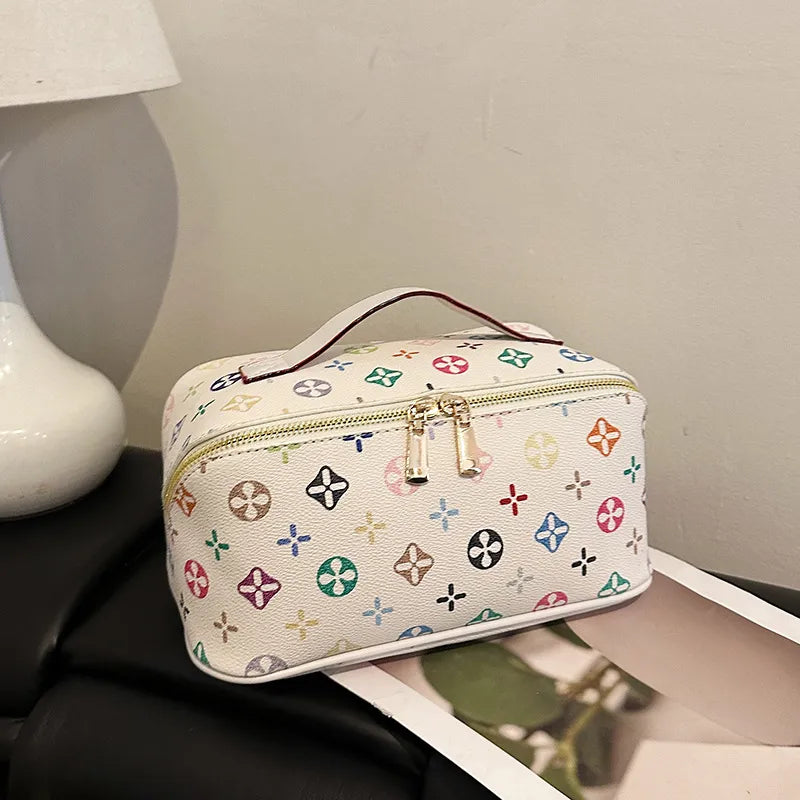 Side perspective of the handheld cosmetic bag showing carrying handle