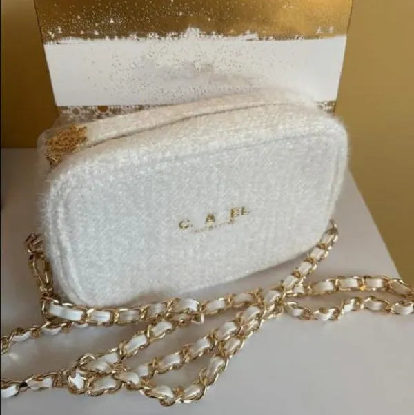Front view of plush round cake cosmetic bag with zipper closed