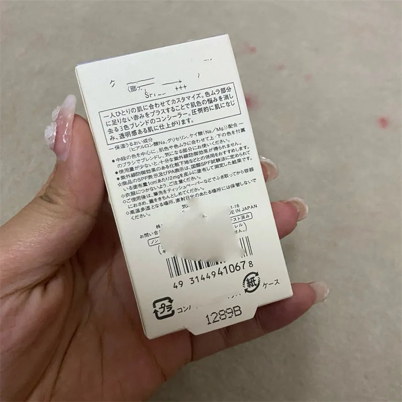 Compact with three shades of cream concealer and a small brush
