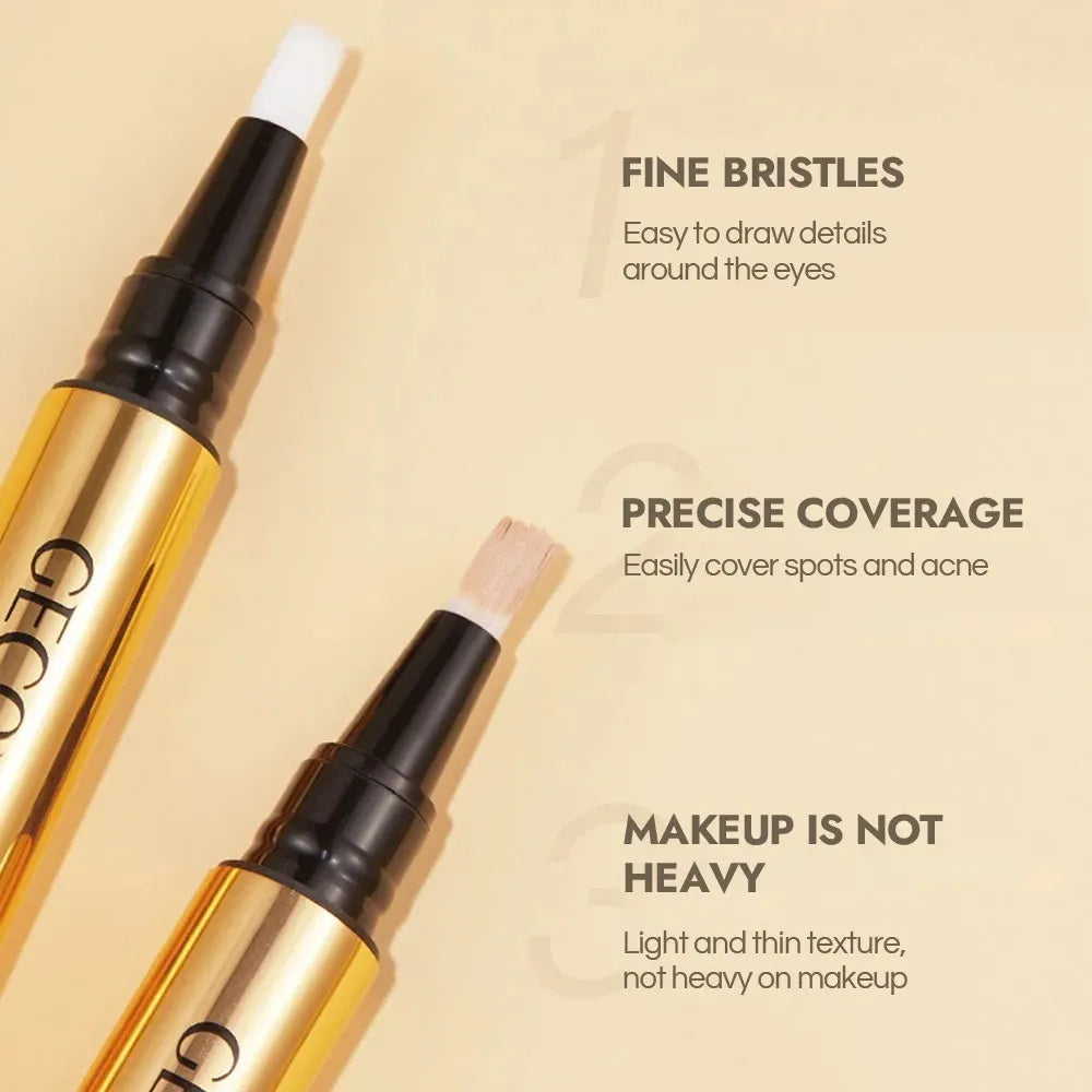 Hand holding concealer pen with product swatch on skin