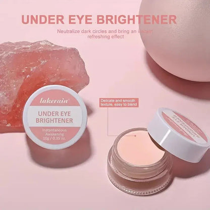 Close-up view of concealer cream being applied to under-eye area