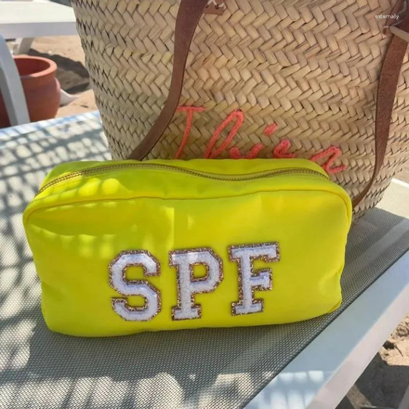 Waterproof nylon cosmetic bag with zipper closure in closed position