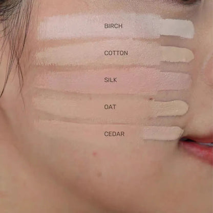 Concealer being applied to under-eye area with blending brush