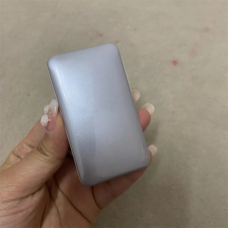 Compact with three shades of cream concealer and a small brush
