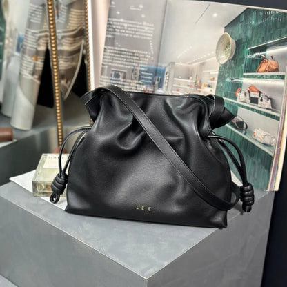 Front view of a leather flamenco clutch bag with chain strap