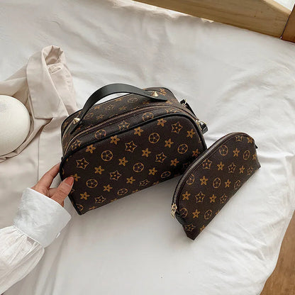 Front view of monogram hand-held makeup bag showing pattern
