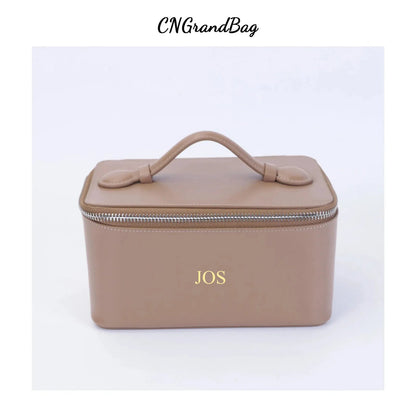 Front view of leather makeup bag showing handheld design and closure