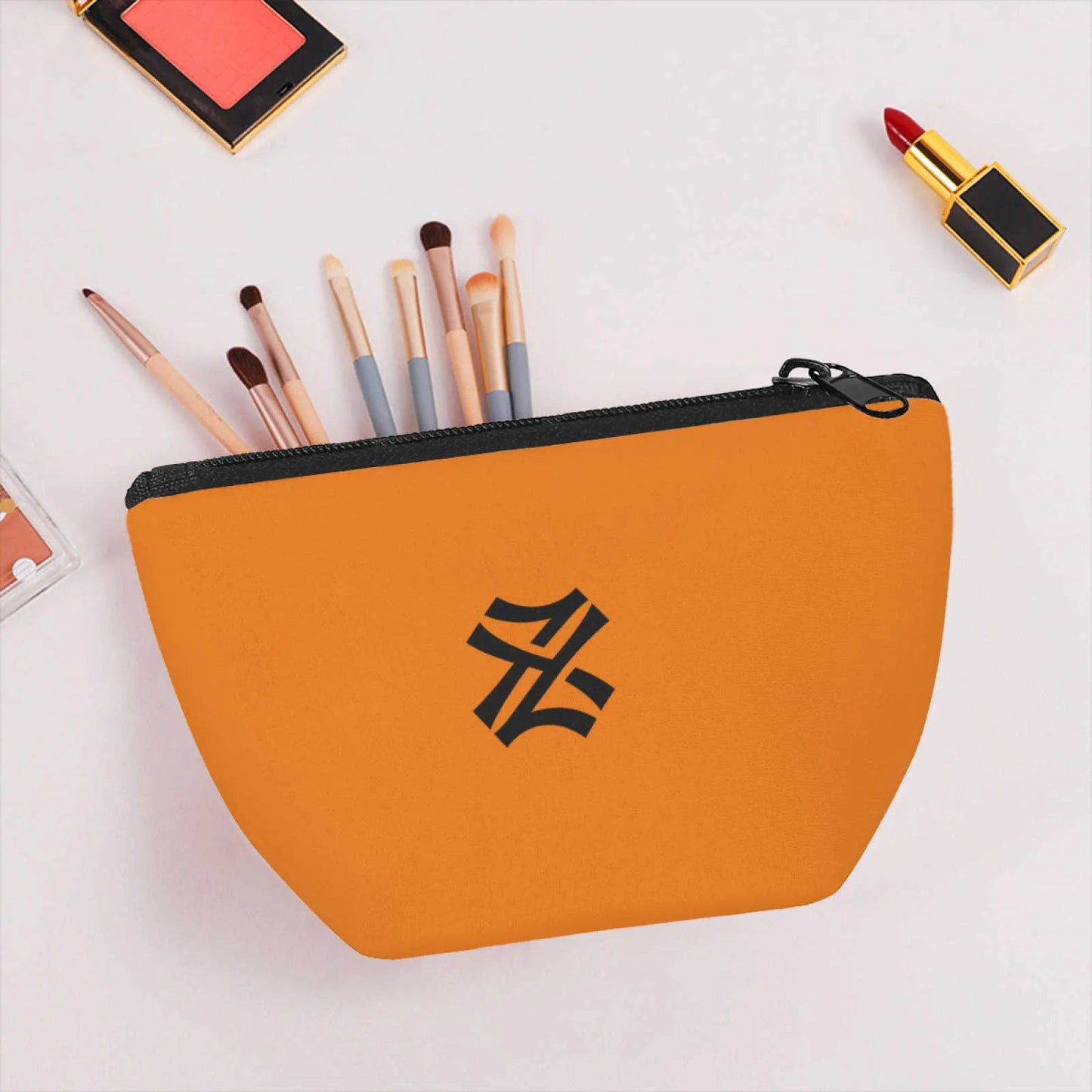 Cosmetic bag displayed with makeup brushes and beauty products