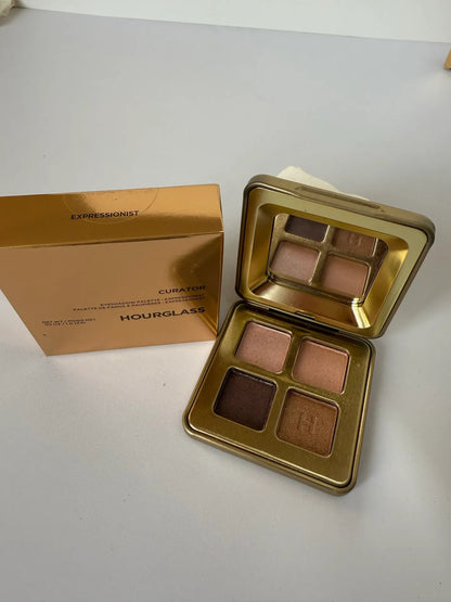 Quad eyeshadow palette showing four pressed powder shades with metallic finish