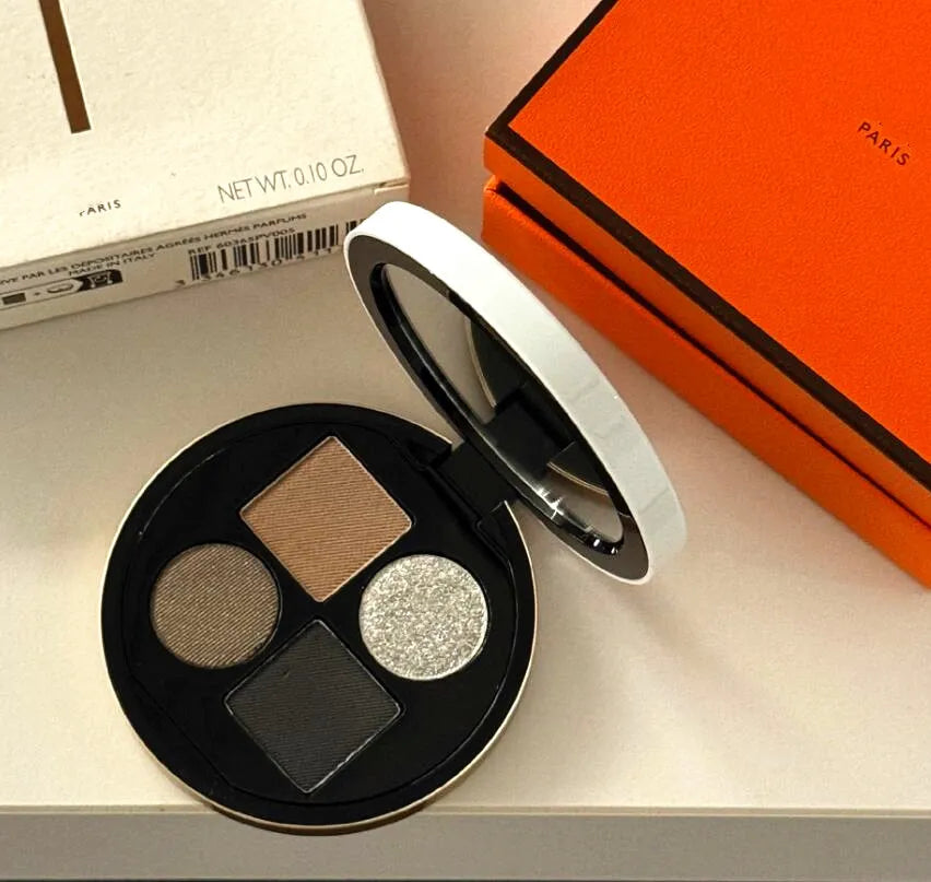 Compact eyeshadow palette with four neutral color pans