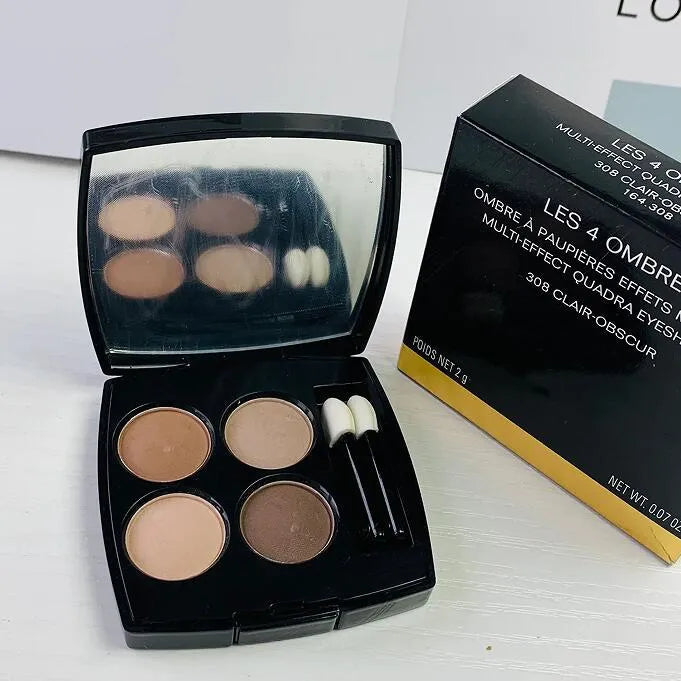 Front view of a 4-color eyeshadow palette with brush and glitter highlighter