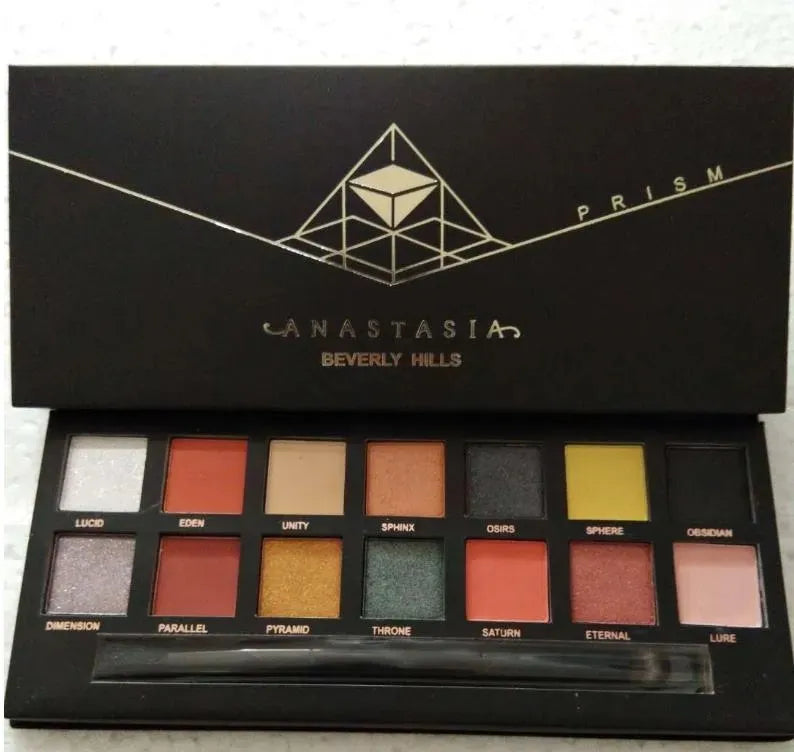 Open eyeshadow palette displaying matte and shimmer finishes in multicolor tones