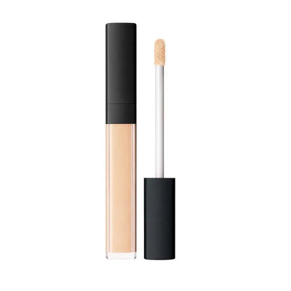 Close-up view of creamy concealer formula being applied to skin