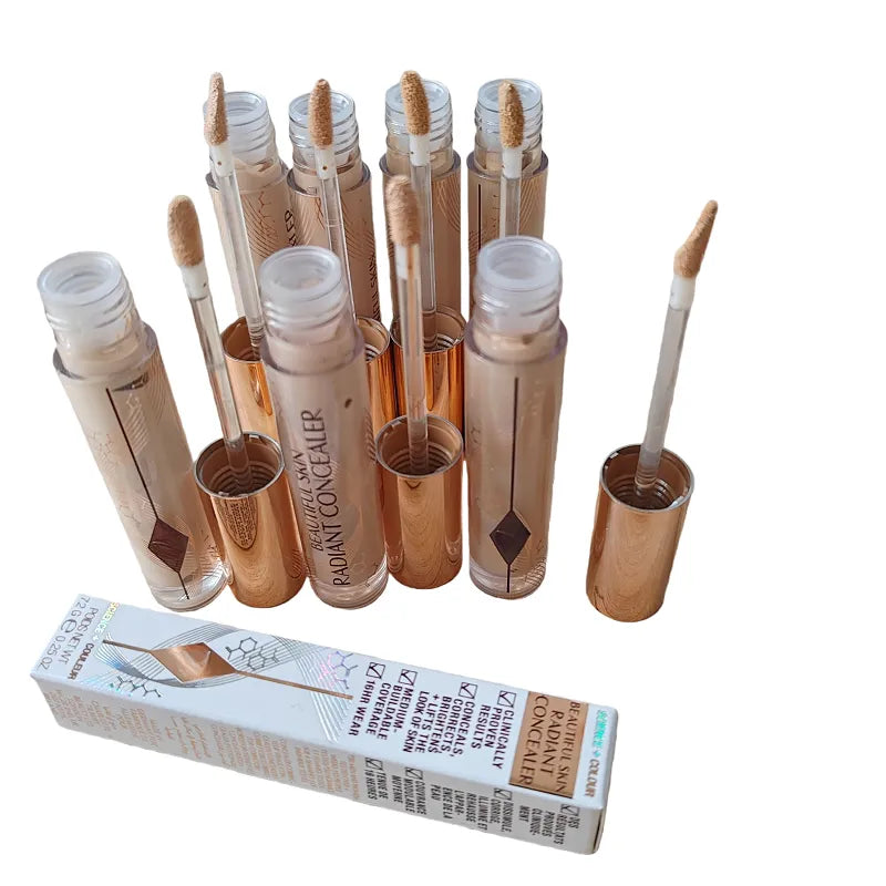 Liquid concealer in tube with doe-foot applicator on white background