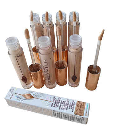 Liquid concealer in tube with doe-foot applicator on white background