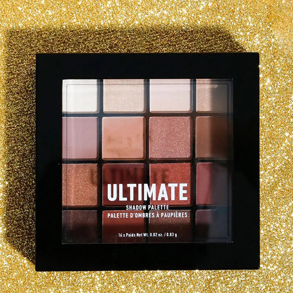 Professional eye shadow palette with warm neutral shades open on table