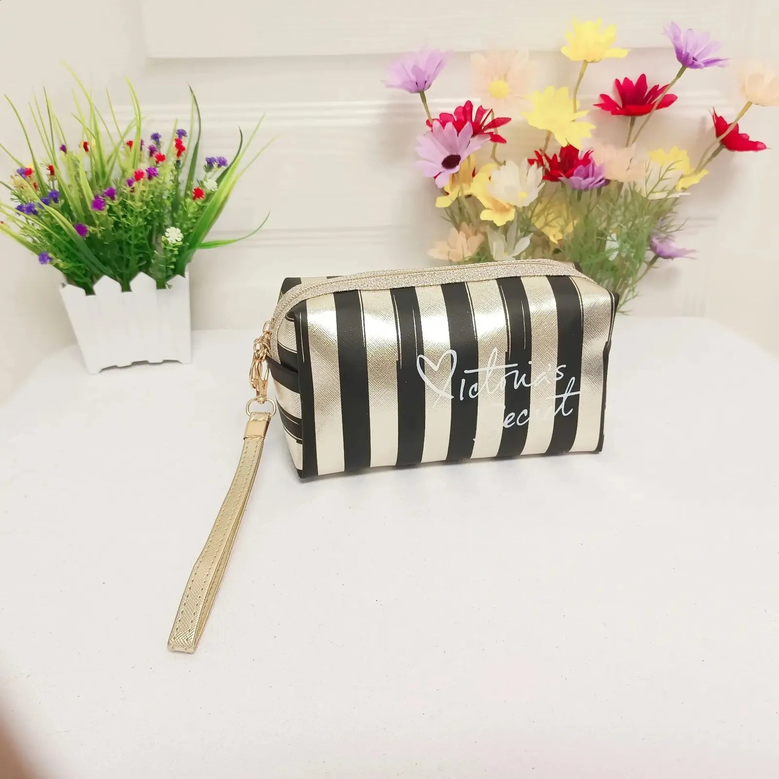 Side view of handheld cosmetic bag demonstrating compact size