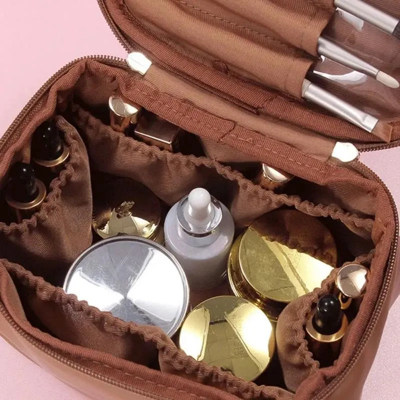 Compact cosmetic organizer in pink color placed next to makeup brushes