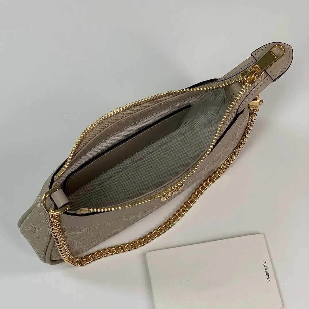 Side angle showing the adjustable strap and zipper closure of the bag