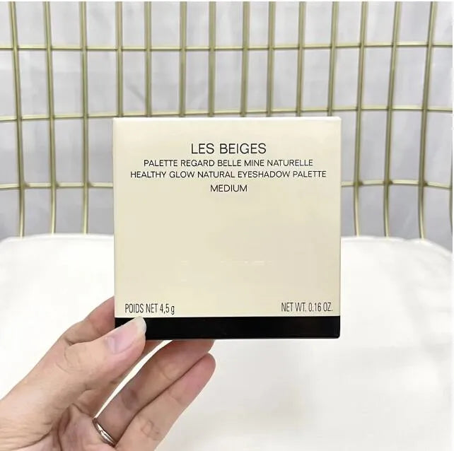 Eyeshadow palette open with mirror and five complementary shades for makeup application