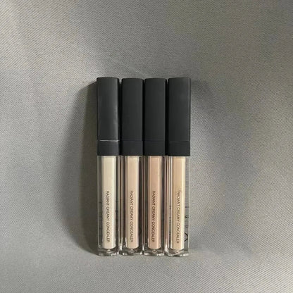 Creamy liquid concealer in a cosmetic container with applicator