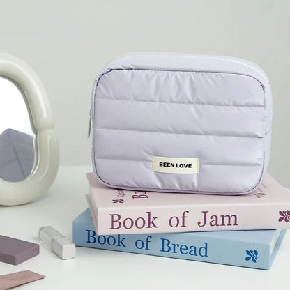 Front view of starry glow patterned makeup bag with handheld strap