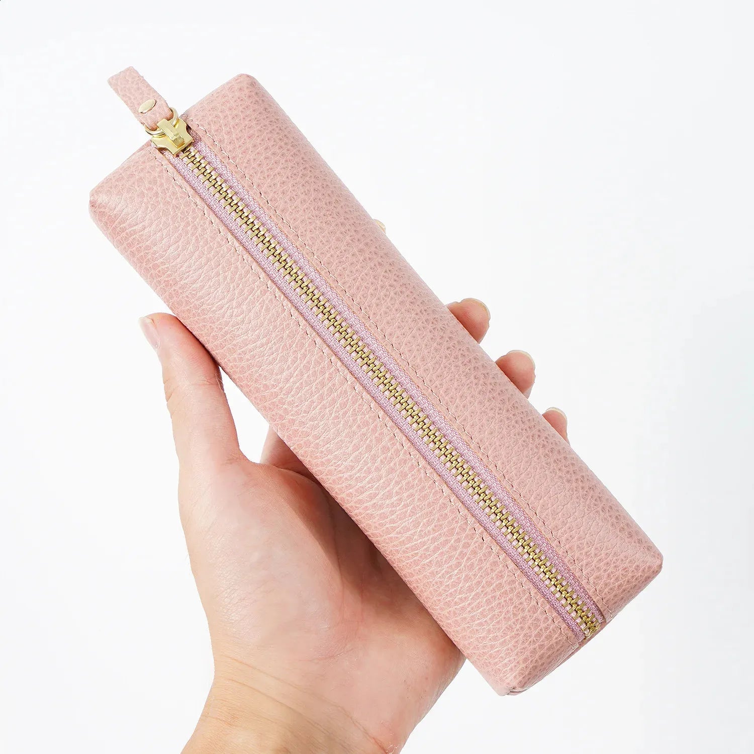 Side profile of monogrammed leather pen box displaying craftsmanship details