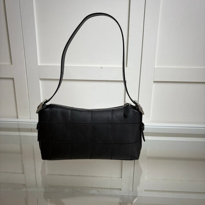 Front view of leather tote bag showing main compartment and strap