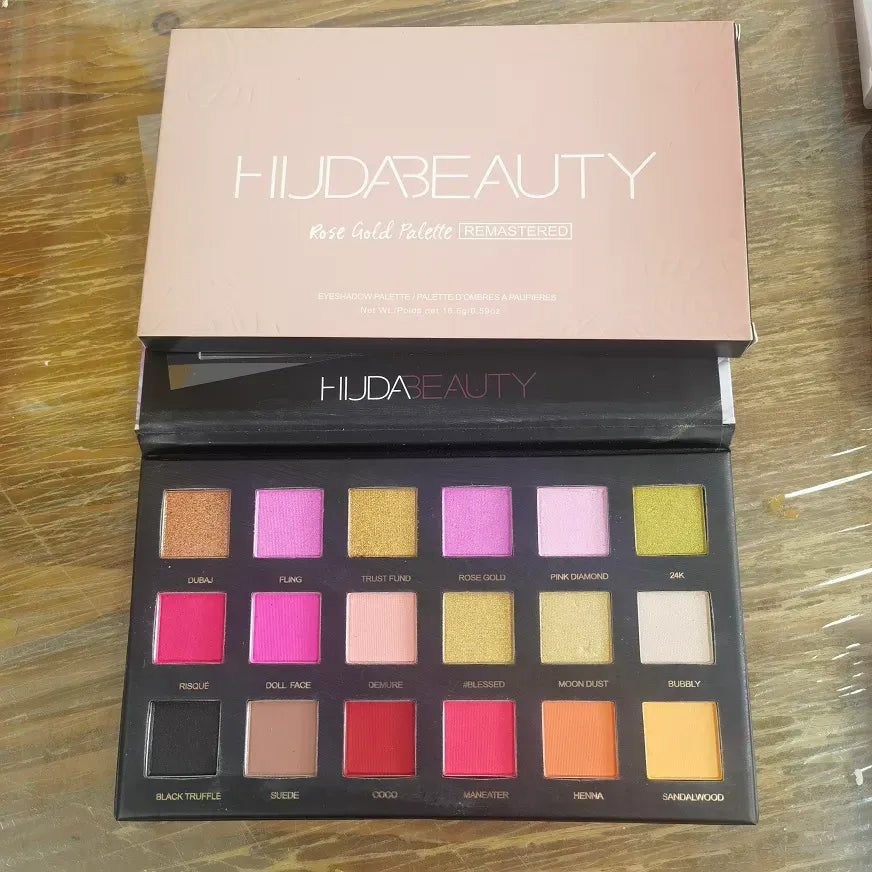 Close-up of eyeshadow palette with brush on side