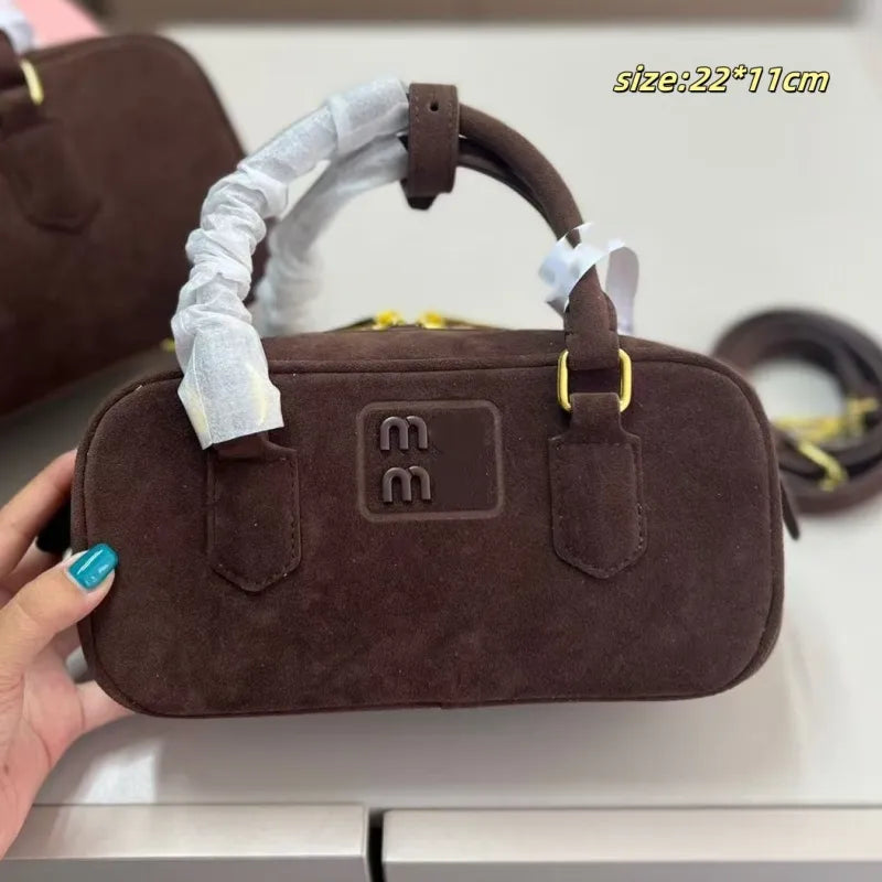 Women's bowling handbag in dark grey color with adjustable strap