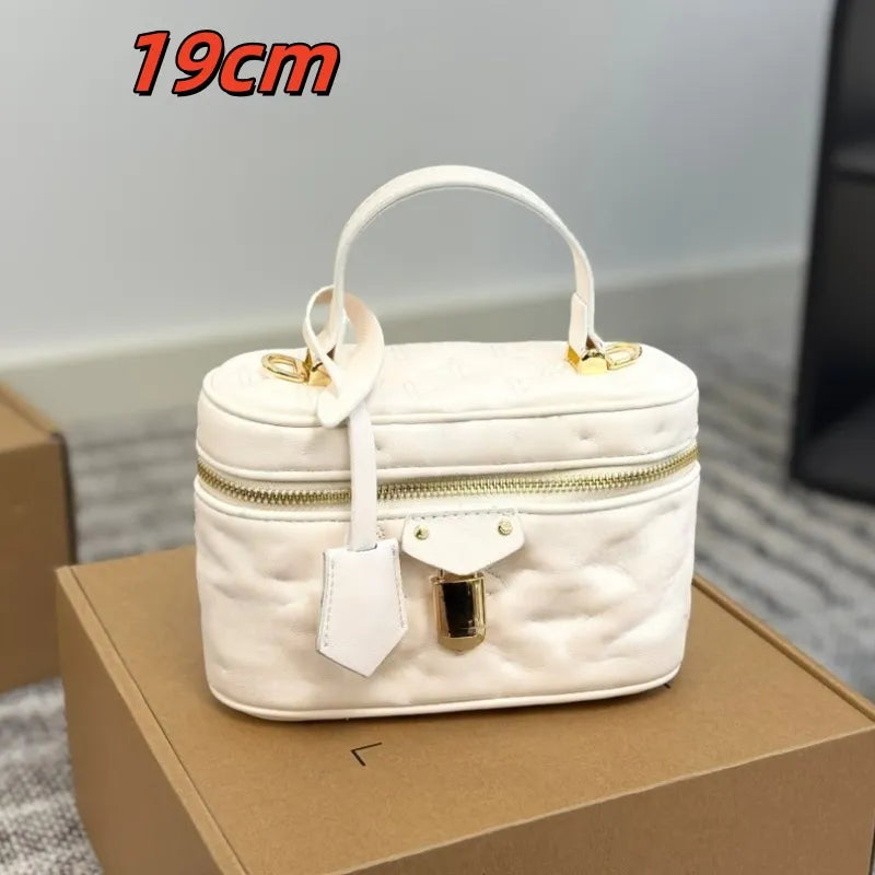 Front view of a mini leather cosmetic bag with crossbody strap