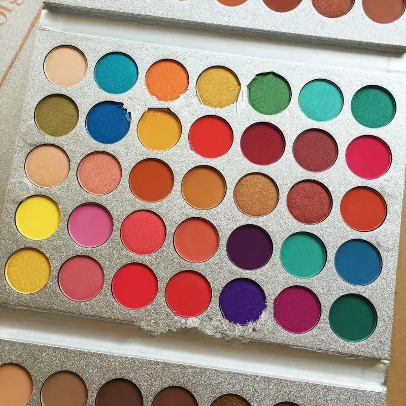 Eyeshadow palette open with color swatches demonstrating pigmentation