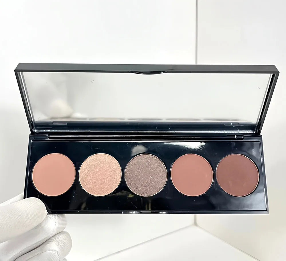 Compact eyeshadow palette open with a mirror and five color pans