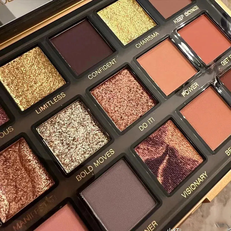 Open eyeshadow palette displaying neutral, rose gold, and deeper tone shades