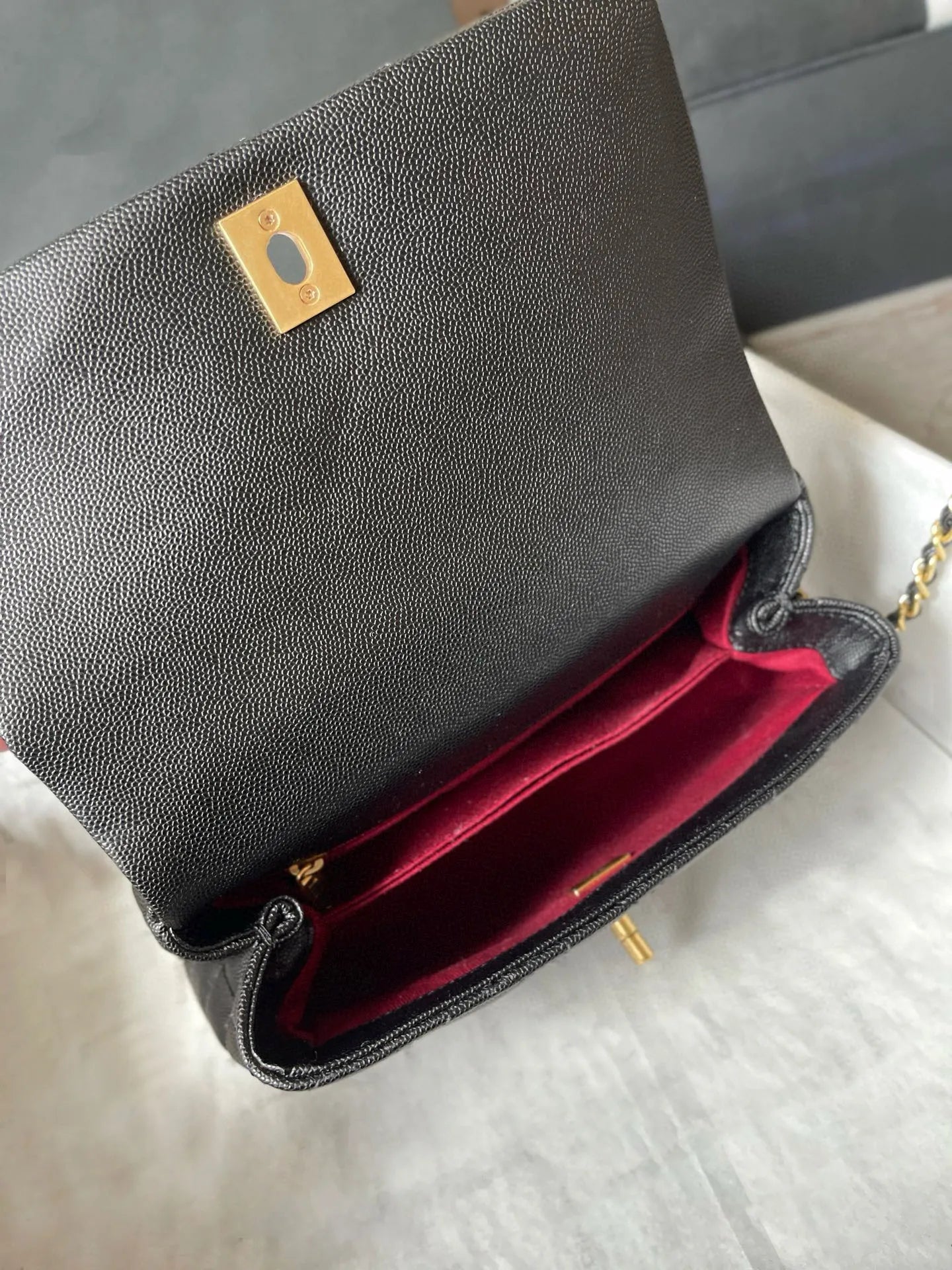 Side angle showing the adjustable strap and structured design of the leather bag