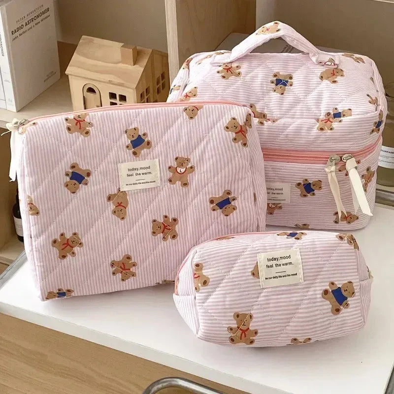 Quilted cosmetic bag with bear design and zipper closure