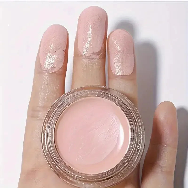 Eye concealer cream in a cosmetic container with applicator